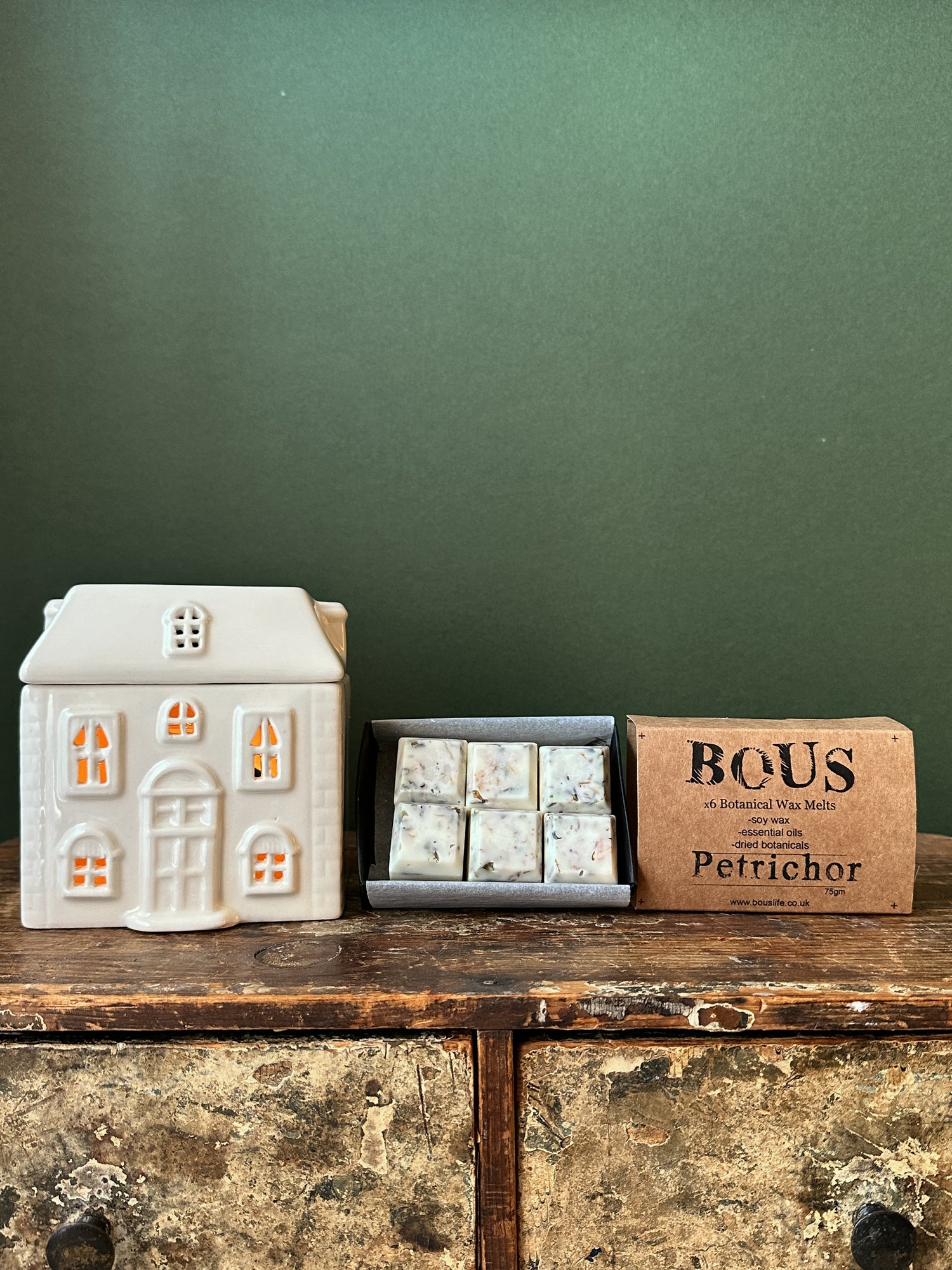 a box of wax melts with ceramic wax melter in the shape of a house 