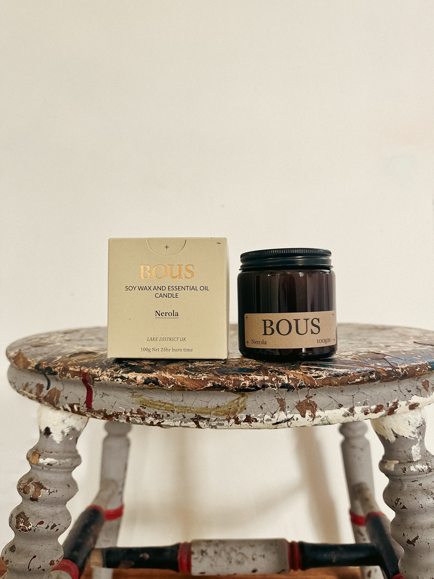 Bous candle and packaging on a rustic table