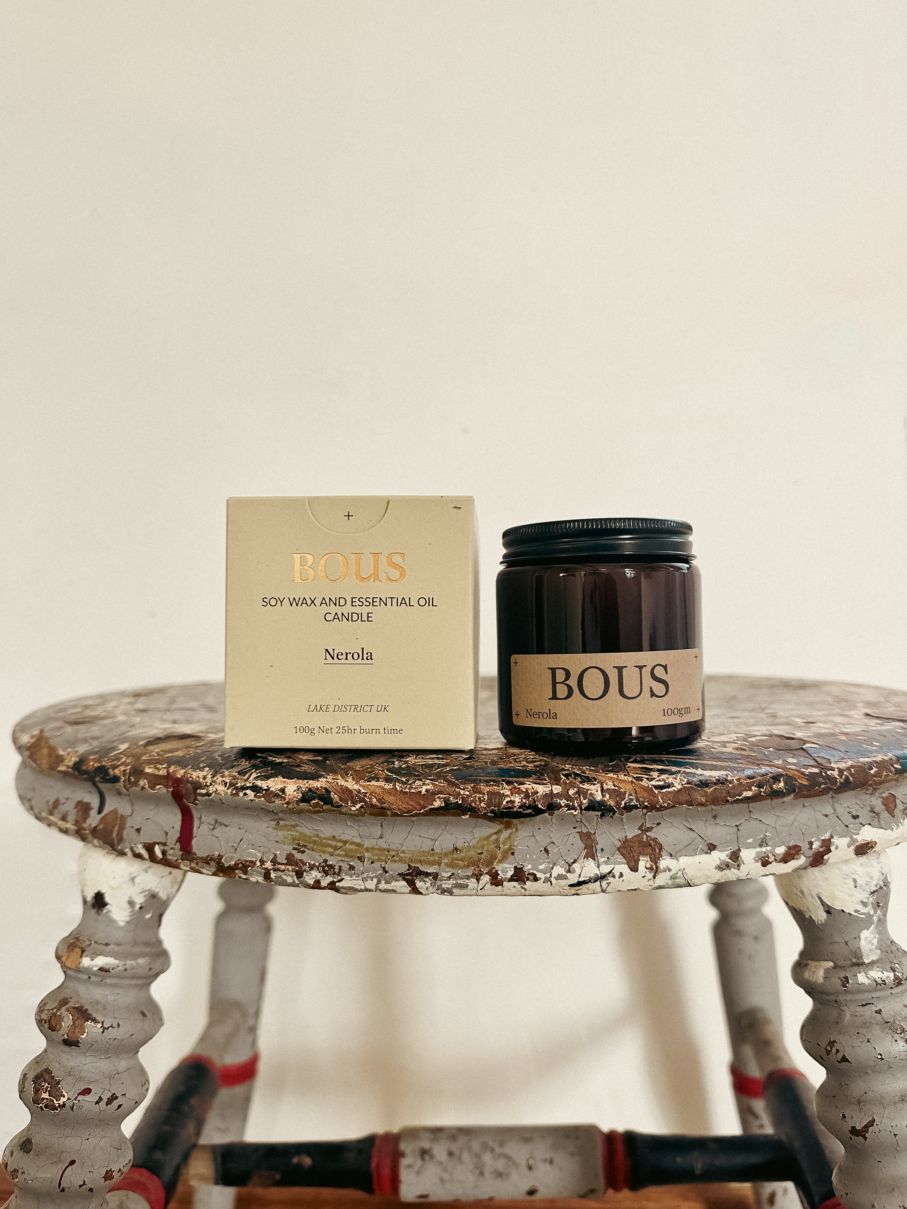 Bous candle and packaging on a rustic table