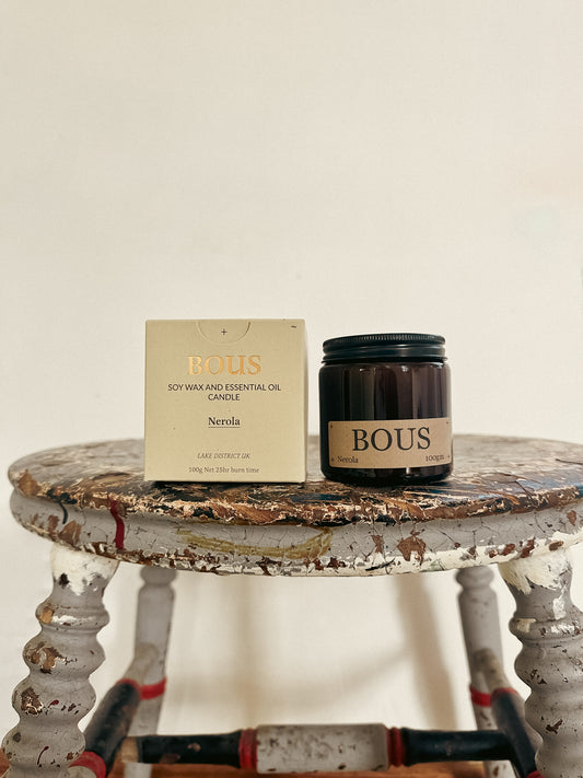 Bous candle and packaging on a rustic table