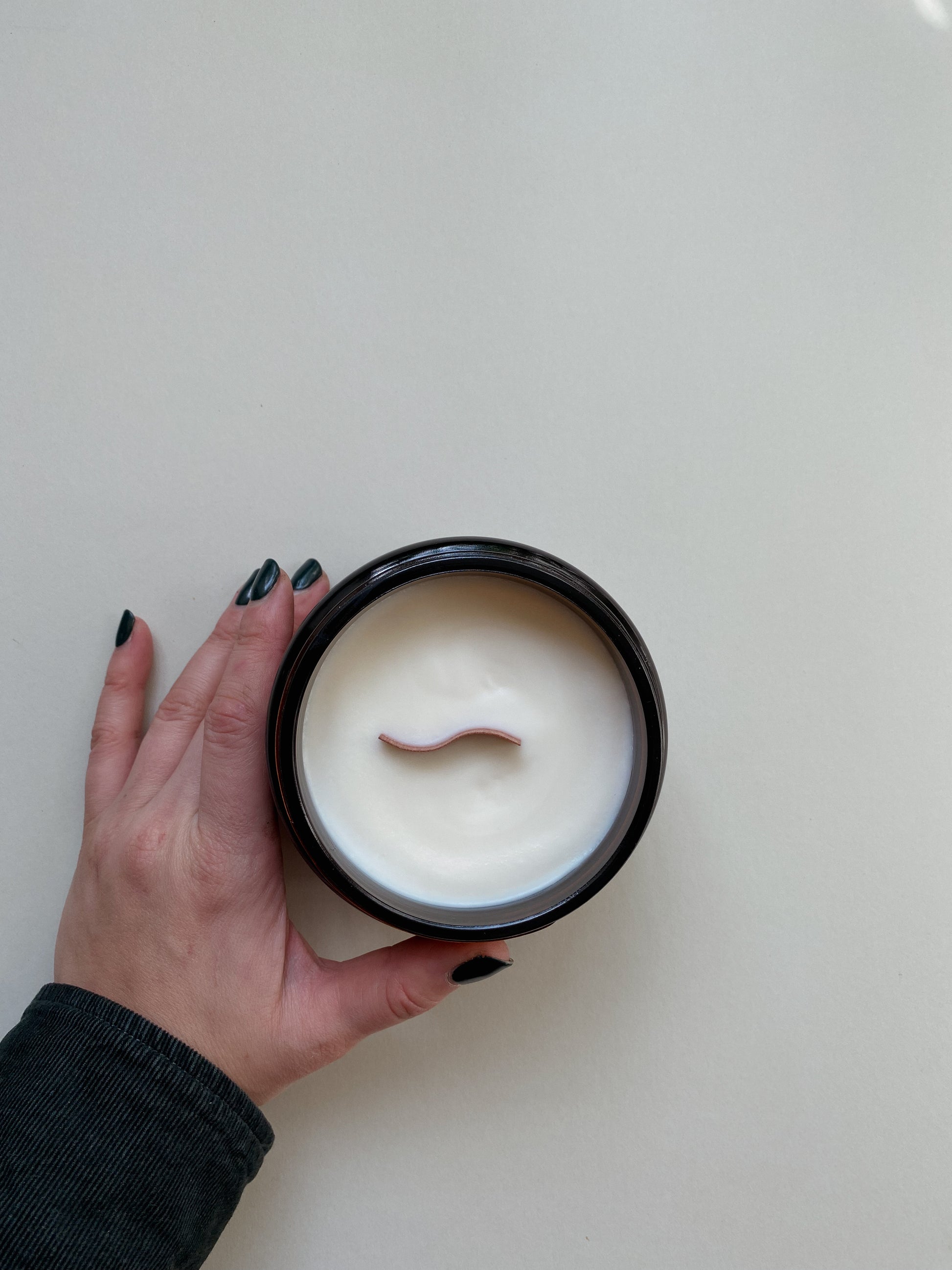 Large Lunette candle in glass amber jar, photo showing wavy wooden wick